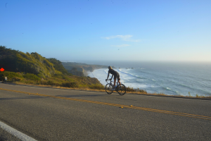 A cyclist rides along Highway 1 between San Simeon and Ragged Point