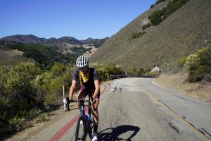 Cyclist Alison Tetrick rides along the right side of a Central Coast roadway