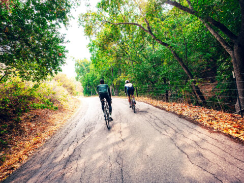 Two cyclists riding road bikes on Santa Rita Road near Cambra, CA, on the Central Coast
